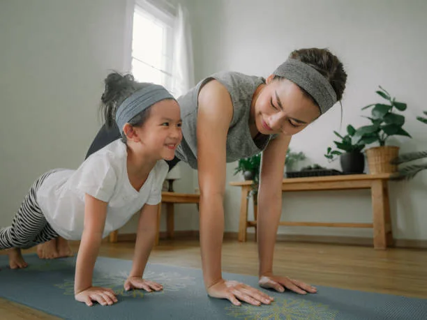 Parent and child exercising together at home