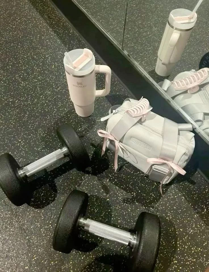Dumbbells, shoes, and water bottles in a gym