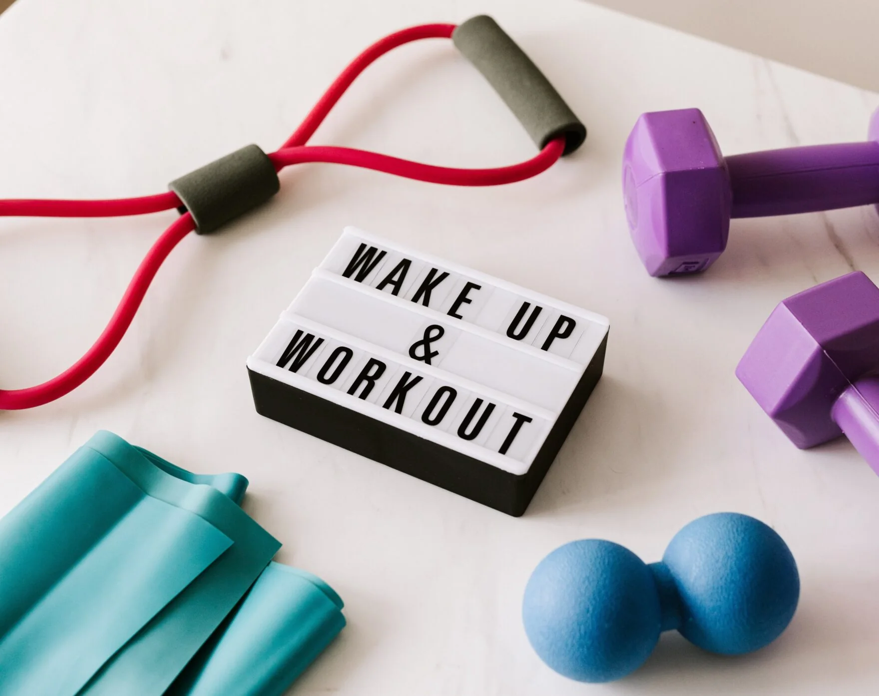 Colourful fitness equipment and a wake up workout sign